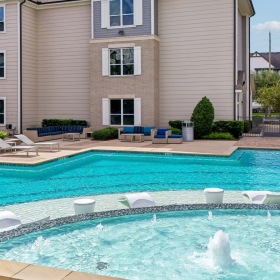 Resort-style swimming pool with lounge seating