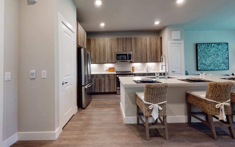a kitchen with an island and chairs