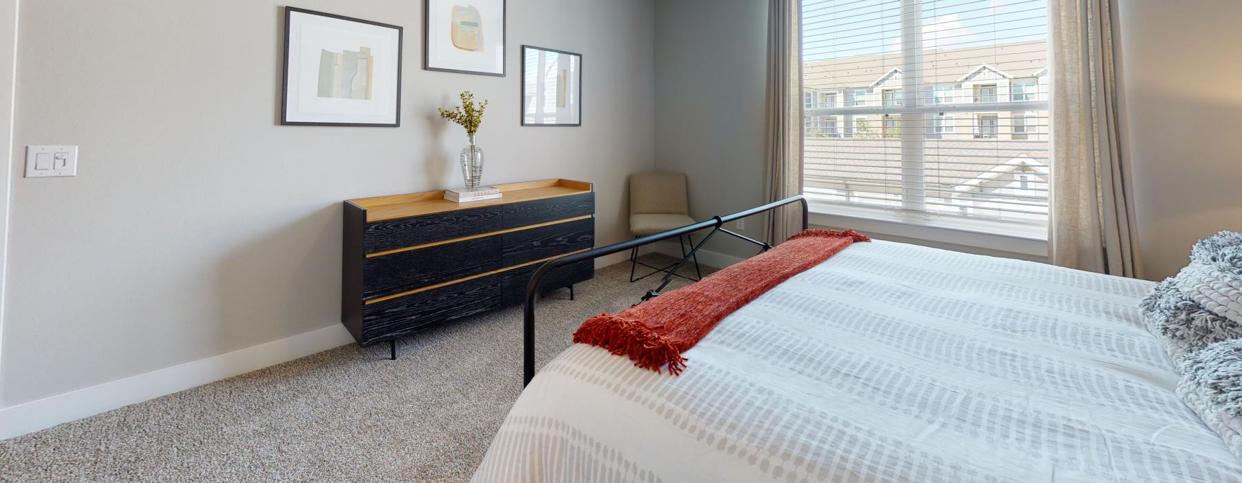 a bedroom with a bed and a wardrobe and a window