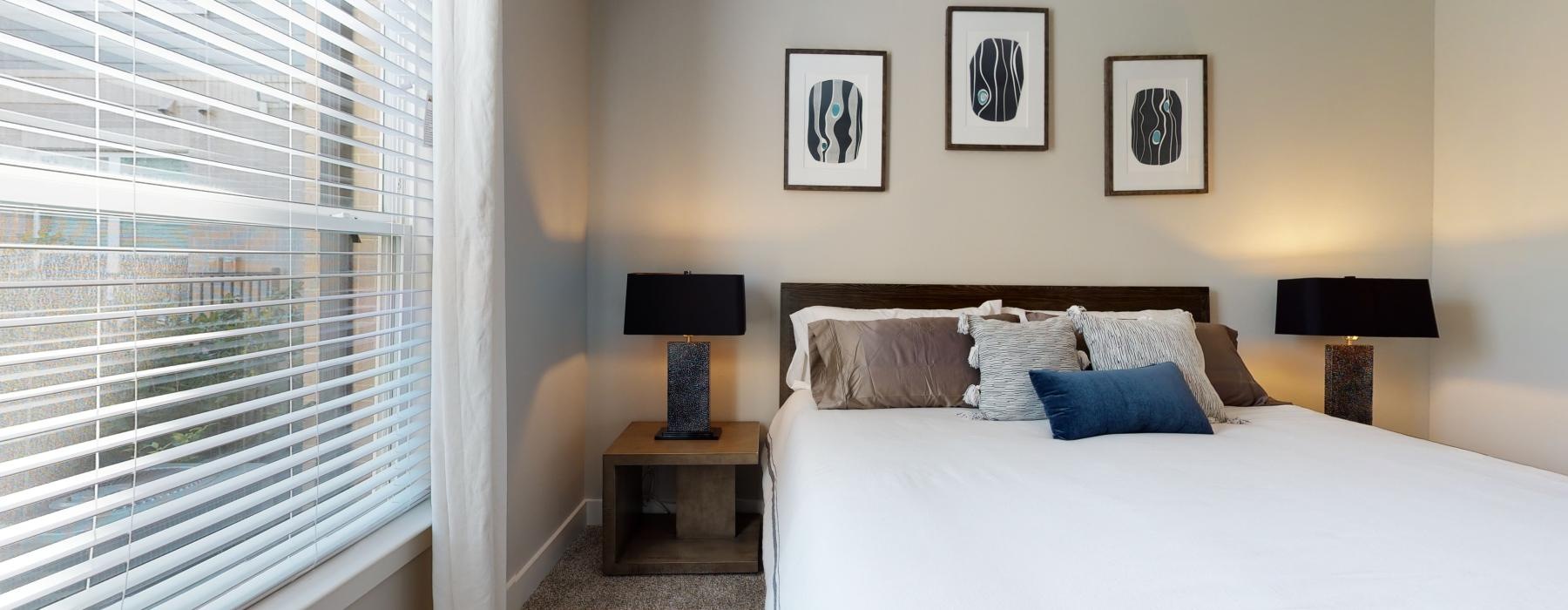 a bedroom with a bed with a lamp on the side